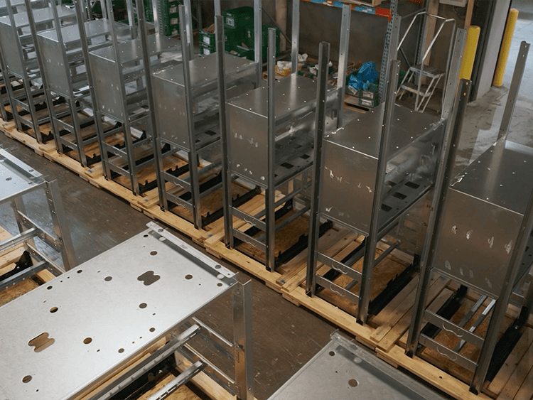 row of metal frames resting on wooden pallets